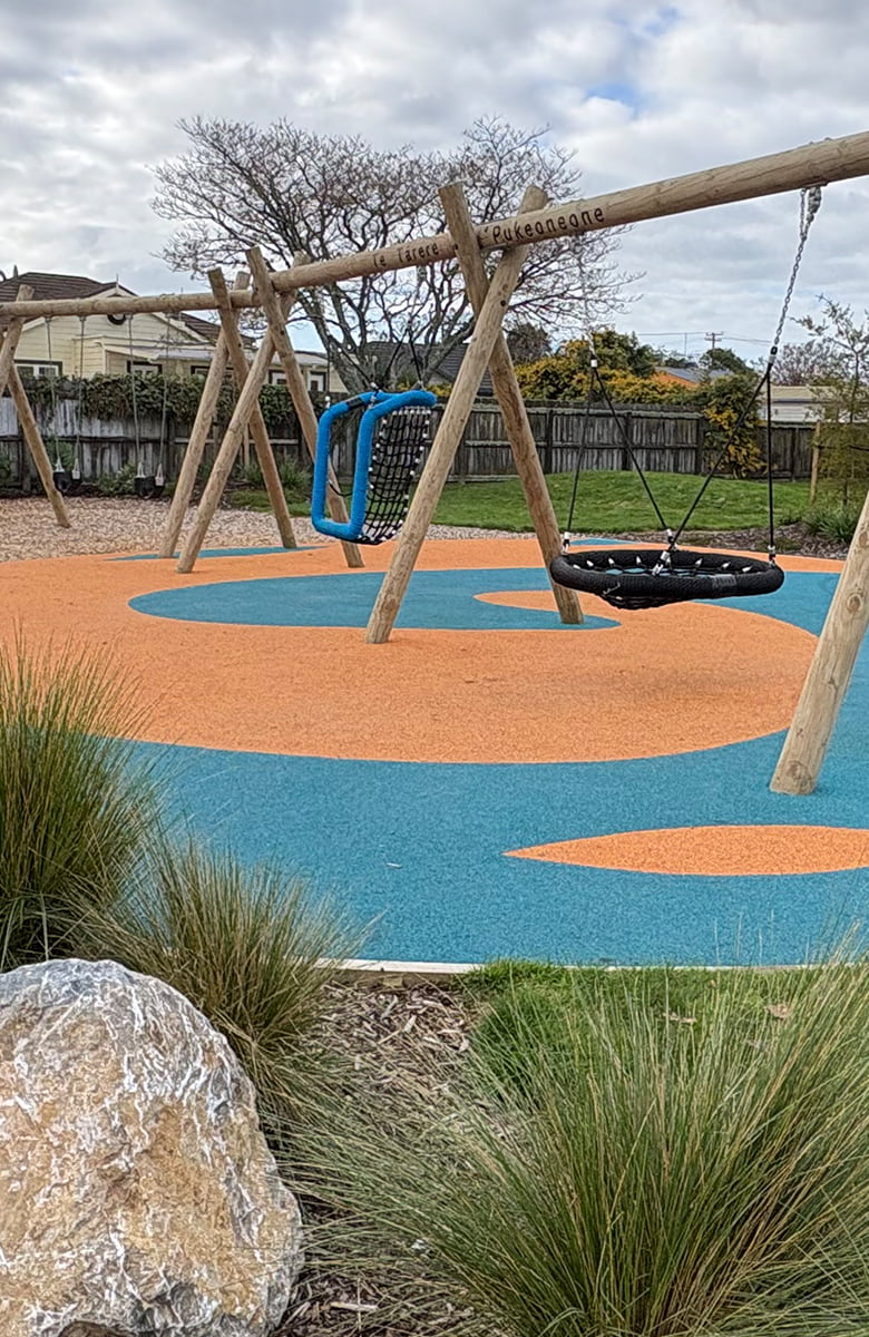 Closer view of the timber swing structure and basket swing at Decks Reserve Playspace