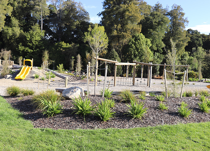 Timber rope climbing and balance structures integrated into landscaped planting at Faulkner Bush Scenic Reserve