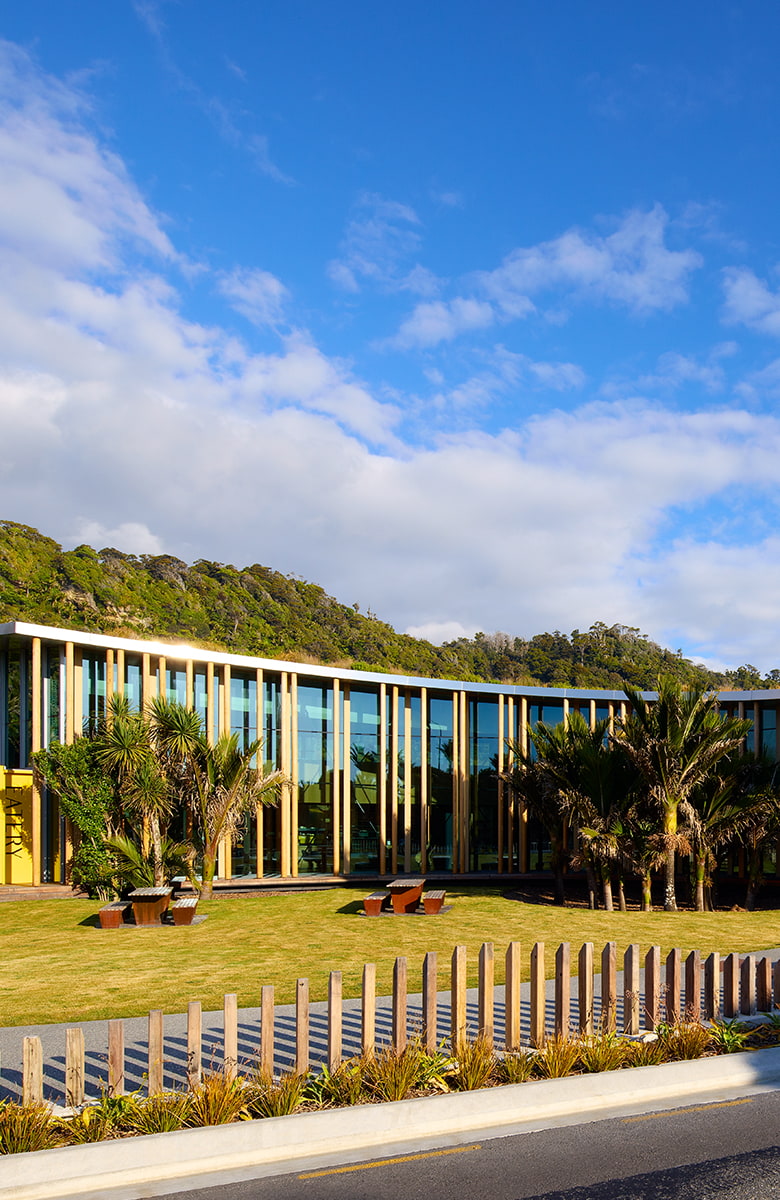 Portrait elevated view showing the curved roof, central lawn courtyard, and surrounding landscape